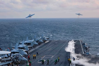 F/A-18s from VFA-81, left, and an VFA11 launch from USS Harry S. Truman (CVN 75) during flight operations in the Atlantic Ocean.