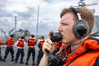 SN Triston Caton communicates through a sound powered phone during a replenishment-at-sea in the Atlantic Ocean aboard USS Harry S. Truman (CVN 75).