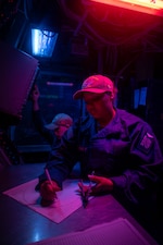 OSSN Celeste Matthews plots the course of nearby surface contacts in the Atlantic Ocean aboard USS Harry S. Truman (CVN 75).