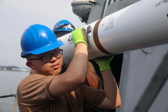 CT2 Andrew Wu moves ordnance aboard USS Dewey (DDG 105) at Fleet Activities  Yokosuka.