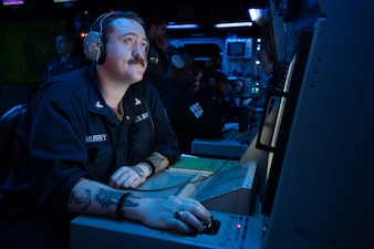 Fire Controlman 3rd Class David McMurrey stands watch aboard USS Harry S. Truman (CVN 75) in the Atlantic Ocean.