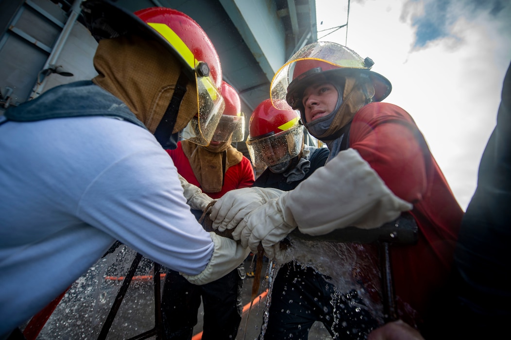 Sailors participate in a damage control Olympics aboard USS Carl Vinson (CVN 70).