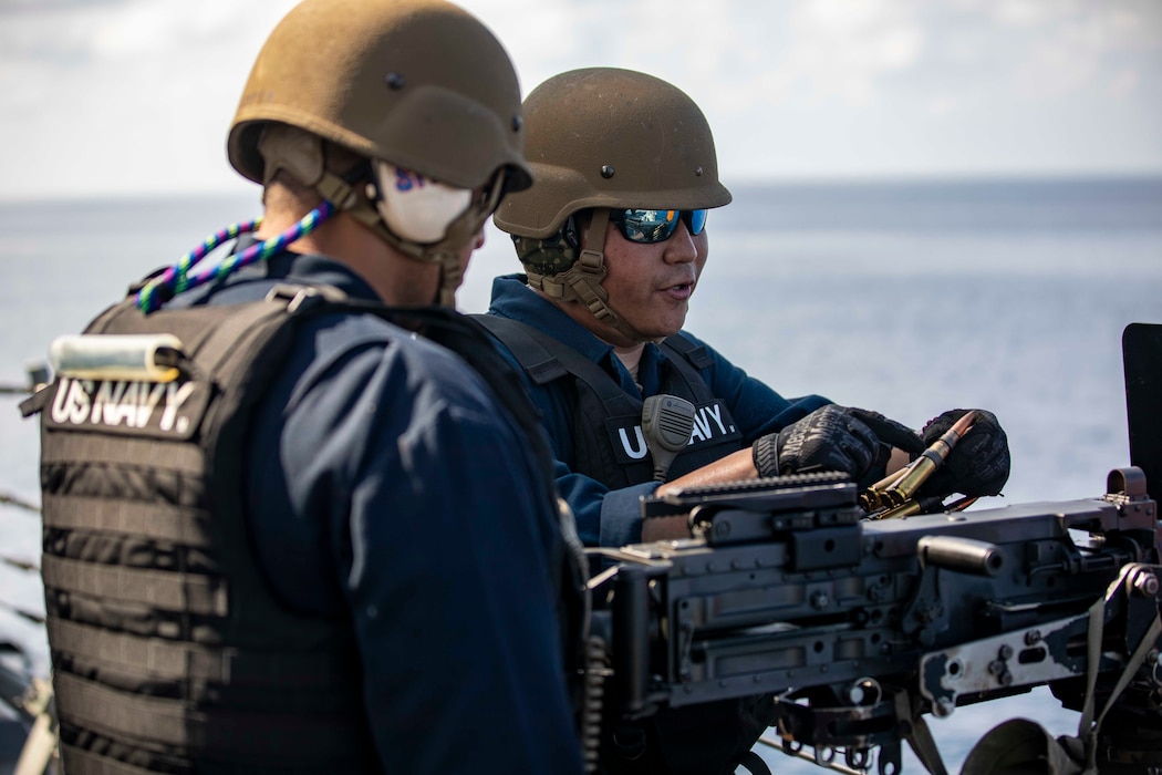 Sailors aboard USS Ralph Johnson (DDG 114) participate in a live-fire exercise in the Sea of Japan.