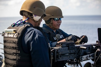 Sailors aboard USS Ralph Johnson (DDG 114) participate in a live-fire exercise in the Sea of Japan.