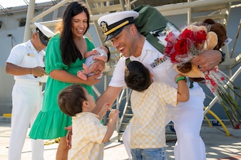 Lt. j.g. Giovanni Guerrero embraces his family as USS Somerset (LPD 25) arrives at Naval Base San Diego.