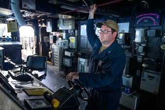 Kaleb Riordan stands watch aboard USS Gridley (DDG 101) while underway in the Pacific Ocean.