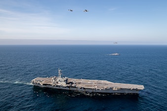 USS George Washington (CVN 73) and ships from the Peruvian navy transit in formation during a photo exercise while underway in the Pacific Ocean.