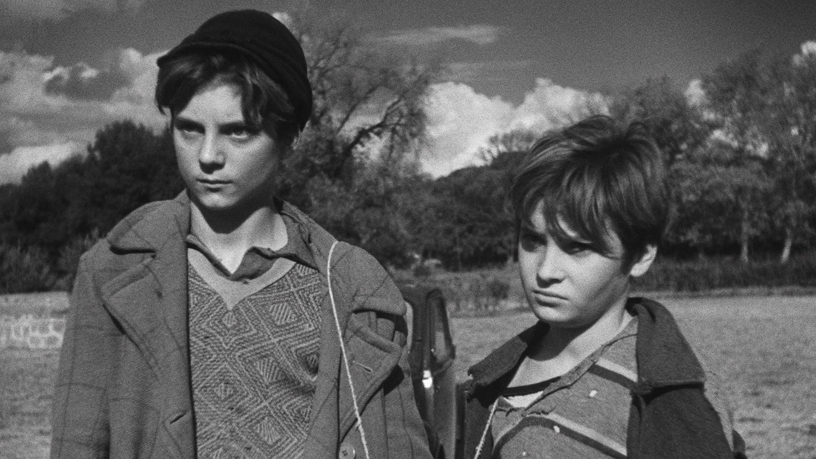 Black and white still from Shoeshine depicting two boys standing side by side.