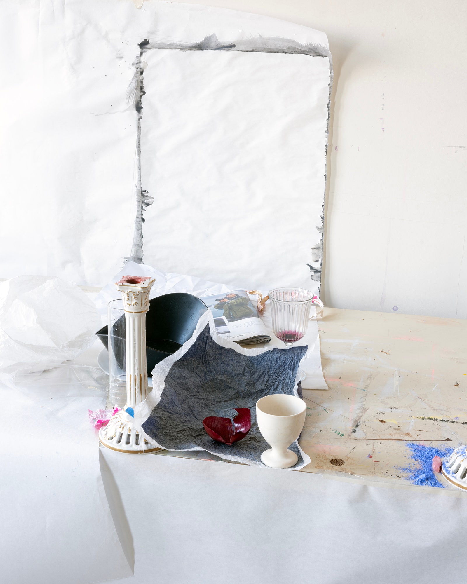 A cup and candlestick on a white background