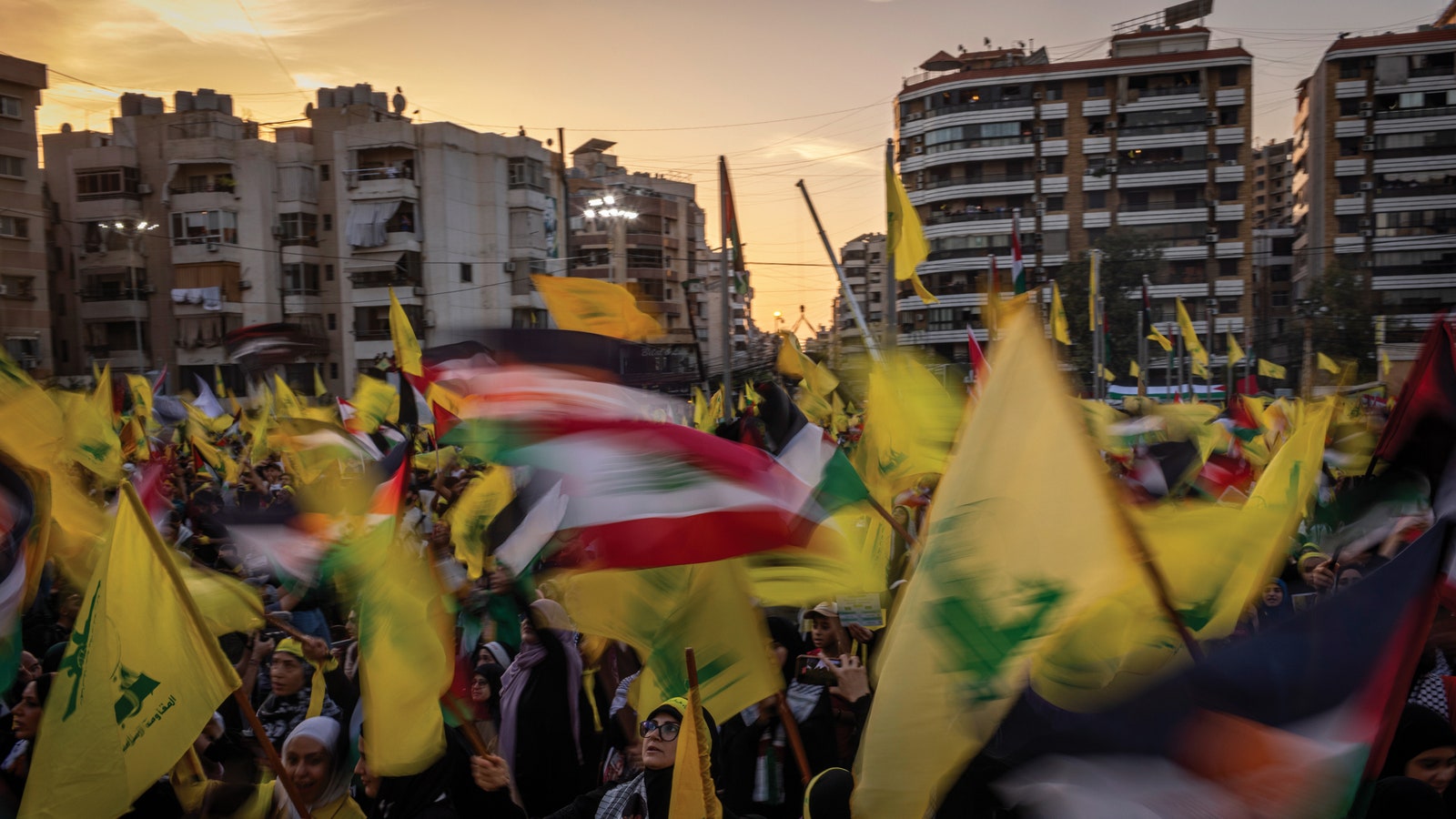 A group of people flying flags in the center of Beirut.