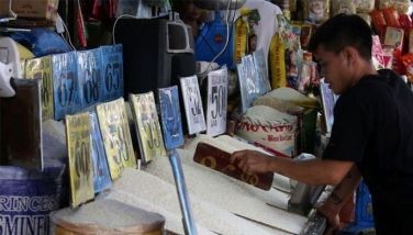 A vendor arranges his rice products for sale at a public market along M. Dela Fuente Street in Sampaloc, Manila on July 14, 2024.