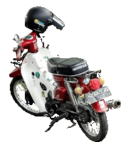 a red honda motorcycle with a black helmet on top