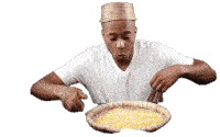 a man in a white shirt is sitting at a table with a basket of rice in front of him