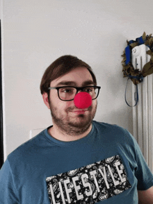 a man wearing a red nose and a lifestyle shirt