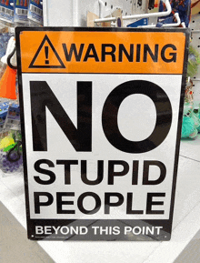 a warning sign that says no stupid people