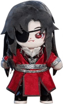 a stuffed toy of a man with long black hair and a red coat .