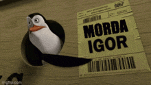 a penguin is sticking its head out of a hole in a cardboard box next to a card that says morda igor