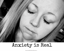 a woman with her eyes closed and the words anxiety is real below her