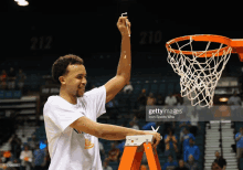 a basketball player with a ladder in front of a basketball net