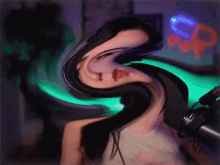 a swirling image of a woman 's face with a neon sign behind her