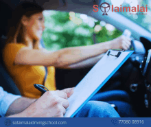 a woman is sitting in a car while a man writes on a clipboard in front of her