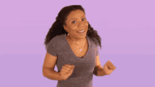 a woman is dancing in front of a purple background with the words aww yeah written on it