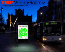 a tedx vitoriagasteiz poster with a bus in the background