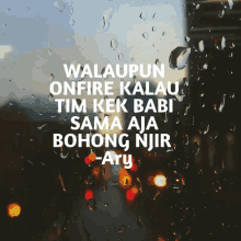 a rainy window with a quote from ary written on it