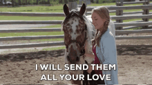 a woman is petting a horse in a fenced in area with the words i will send them all your love below her .