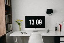 a computer monitor displays the time of 13:03 on its screen