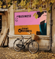 a bicycle is parked in front of a sign that says all business event business