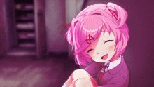 a girl with pink hair and a red x on her forehead smiles