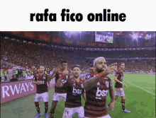 a group of soccer players are celebrating on a field with the words rafa fico online below them