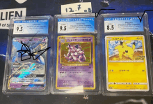 three pokemon cards are displayed in clear plastic cases with one of them being nidoring