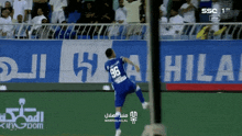 a soccer player wearing a number 96 jersey is jumping in the air