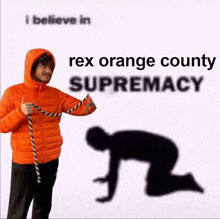 a man in an orange jacket is kneeling down with a rope around his neck and says rex orange county supremacy