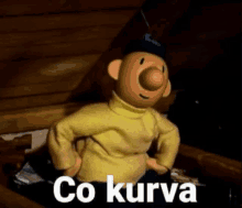 a cartoon character is standing in a dark room with the words co kurva written below him