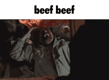 a man is screaming with the word beef below him