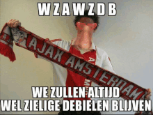 a man holds a scarf that says ajax amsterdam