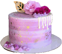 a purple cake with purple frosting and pink flowers