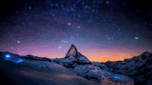 a mountain with a starry sky in the background