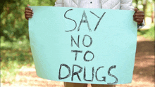 person holding a sign that says say no to drugs