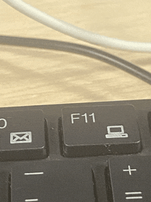 a close up of a keyboard with a f11 key