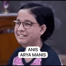 a woman wearing glasses and a pink shirt has a speech bubble that says anis arya manis