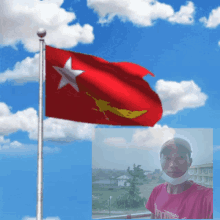 a man wearing a mask stands in front of a flag with a star on it