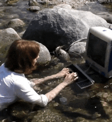 a woman is using a computer in a stream