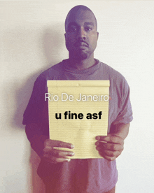 a man holding a piece of paper that says rio de janeiro