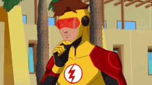 a cartoon character in a yellow and red superhero costume with a lightning bolt on his chest