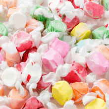 a pile of colorful taffy candy including a pink one