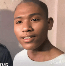 a close up of a young man 's face with a tv5 logo in the background